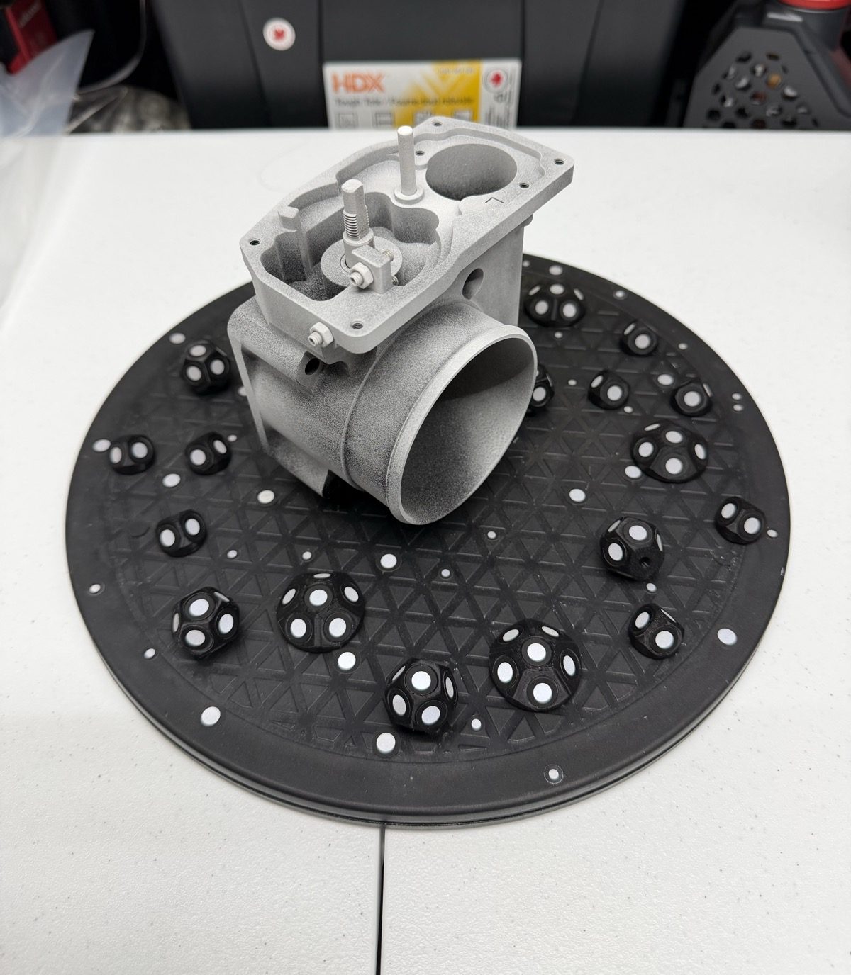 Marker spheres give the scanner fixed points to align every angle into one watertight model.