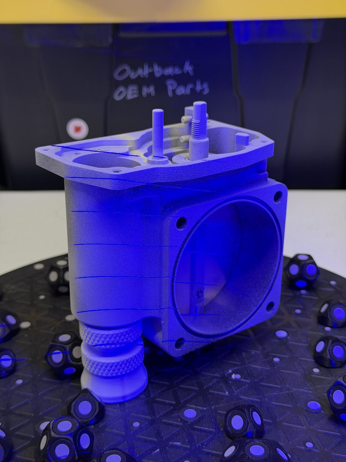 Billet aluminum throttle body under blue structured light during a 0.2 mm 3D scan