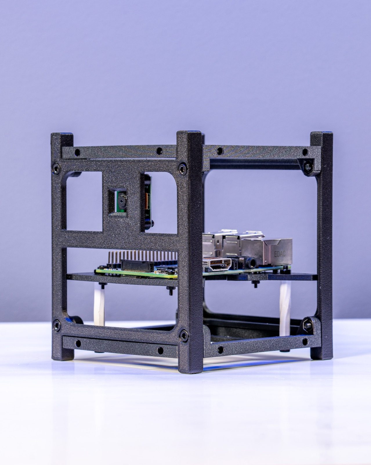1U CubeSat test frame 3D printed in recycled carbon-fiber PETG holding a Raspberry Pi and camera module